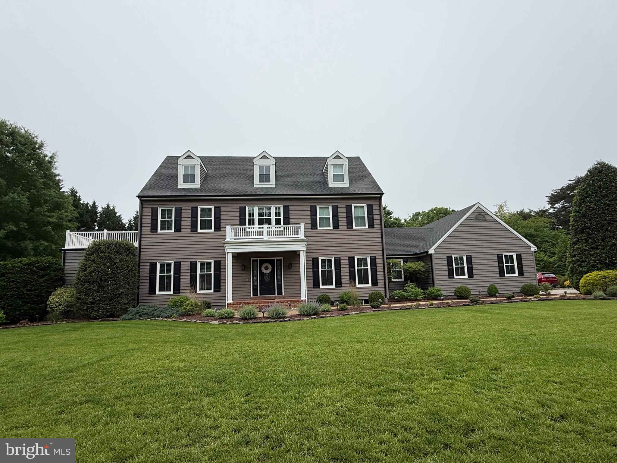 2032 Windswept Drive Dover, DE 19901 - Photo 2 of 2 a front view of a house with a yard table and chairs