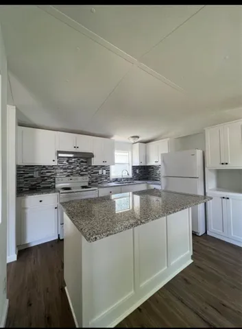 a kitchen with stainless steel appliances granite countertop a sink and cabinets