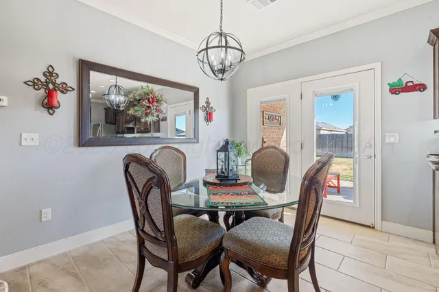 a view of a dining room with furniture wooden floor and a chandelier
