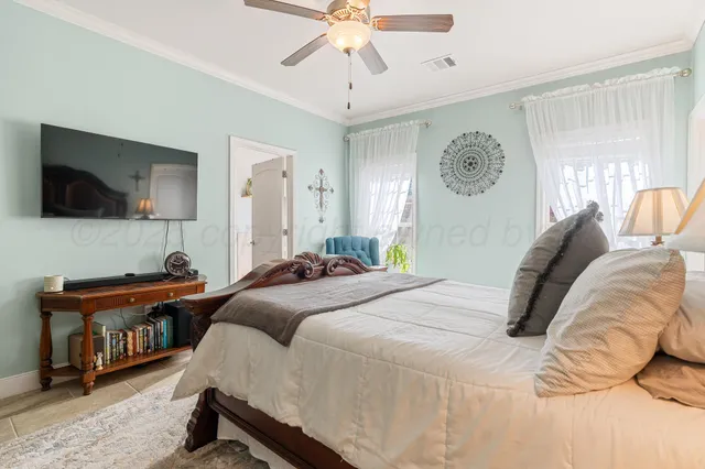 a bedroom with a bed and a flat screen tv
