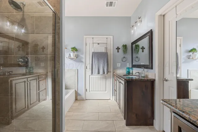 a kitchen with kitchen island granite countertop a refrigerator and a sink