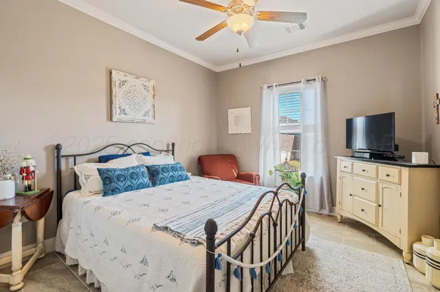 a bedroom with two beds and a flat screen tv