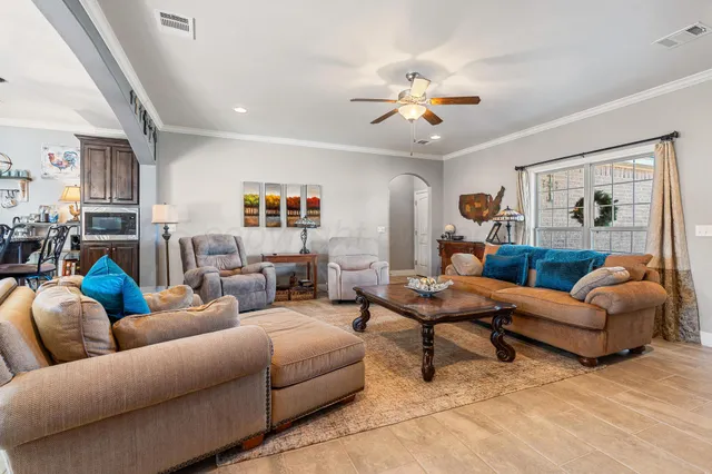 a living room with furniture and a chandelier