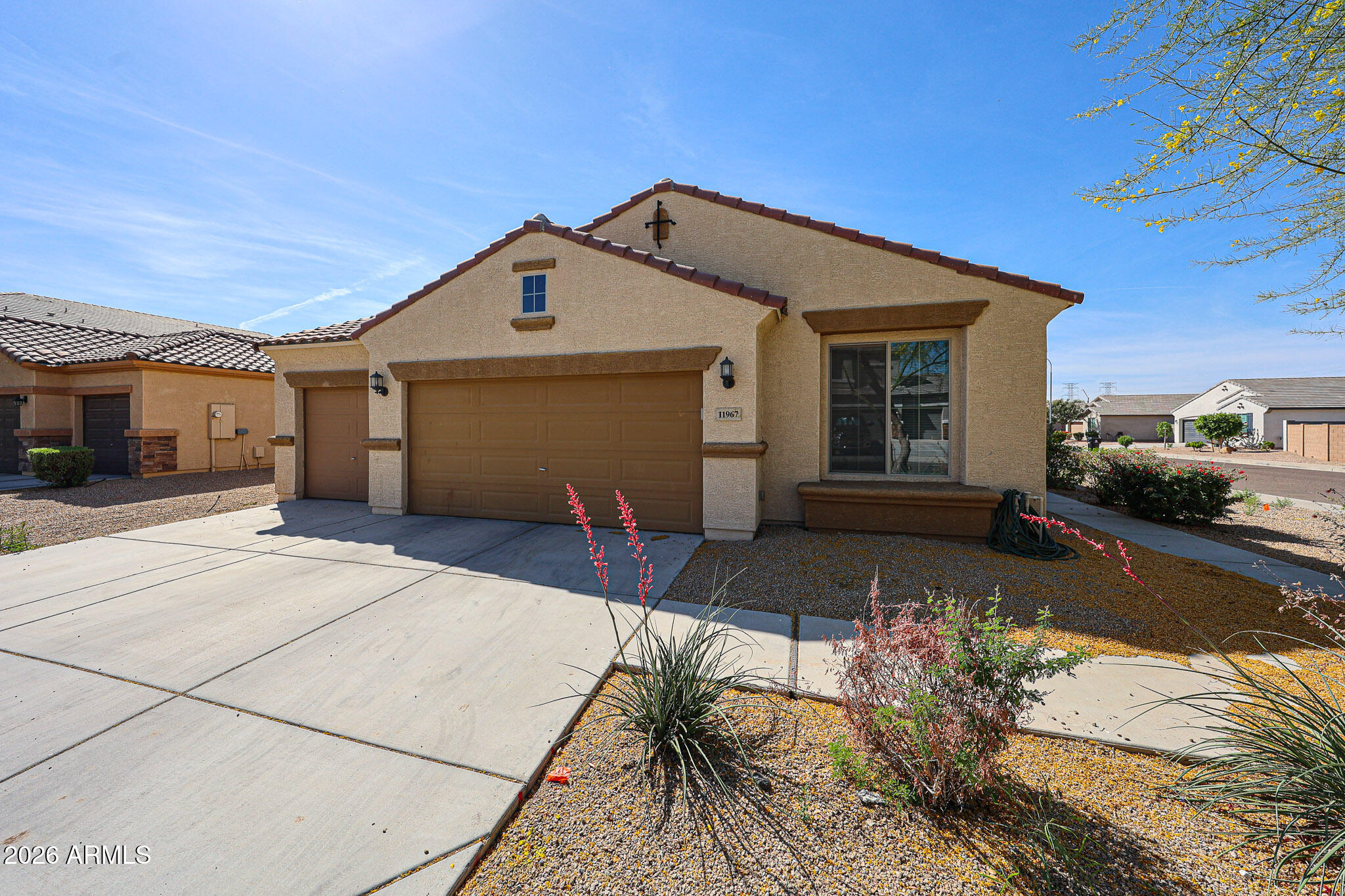 11967 West Rio Vista Lane Avondale, AZ 85323 - Photo 1 of 28 a front view of a house with a yard