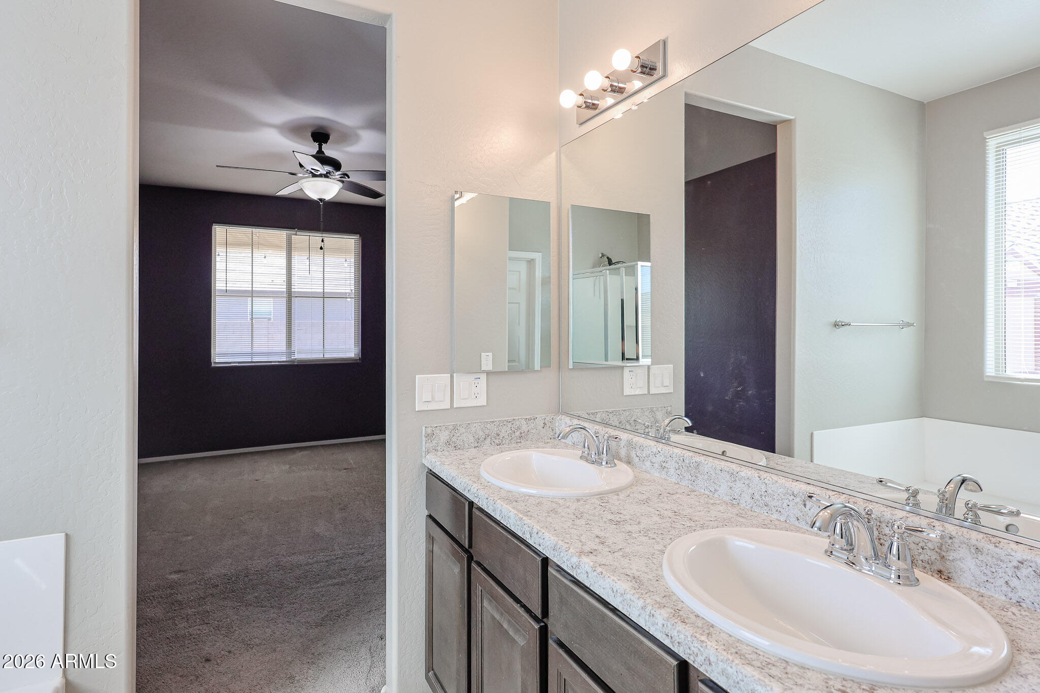 11967 West Rio Vista Lane Avondale, AZ 85323 - Photo 13 of 28 a bathroom with a sink a vanity and mirror