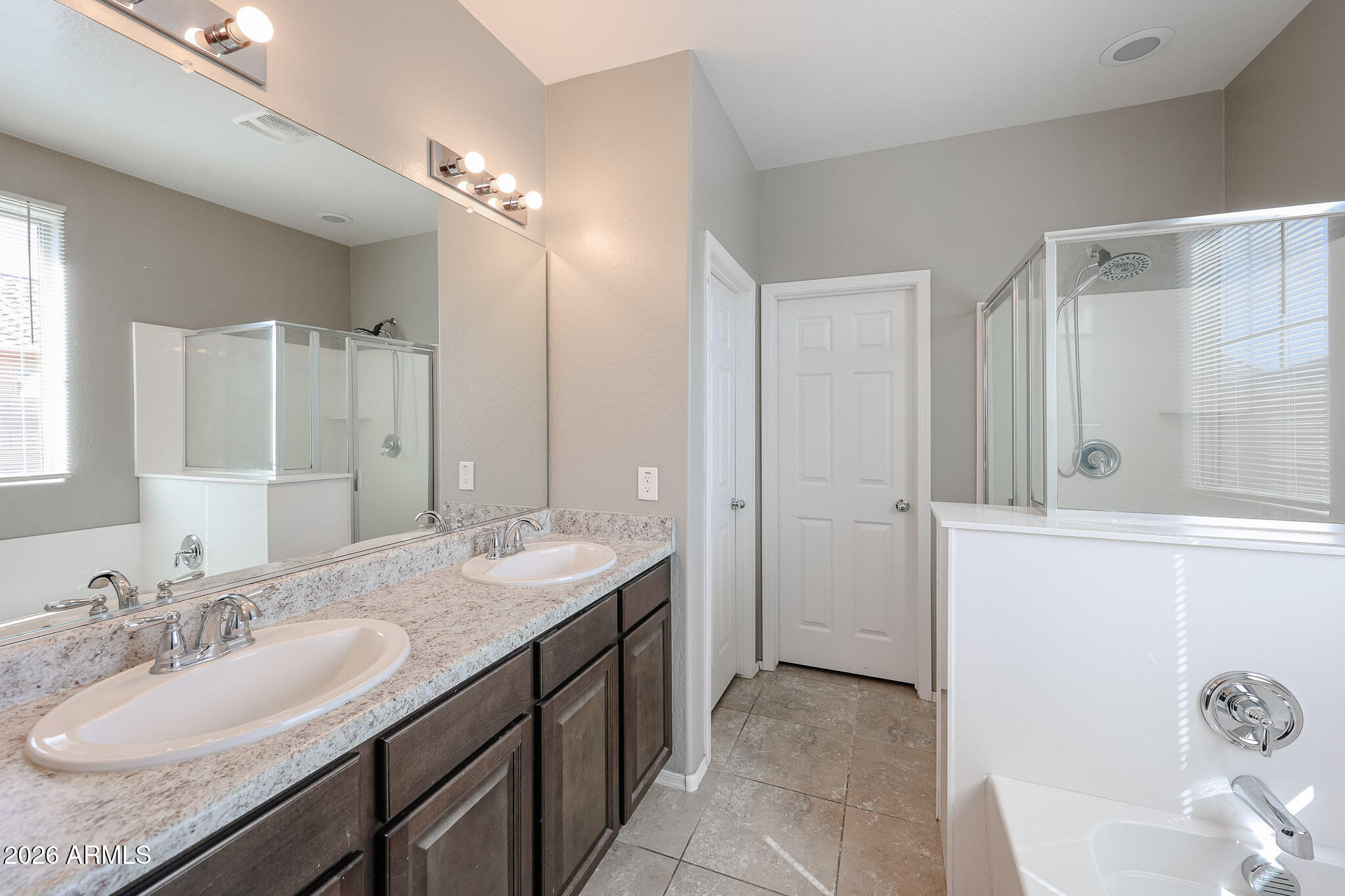 11967 West Rio Vista Lane Avondale, AZ 85323 - Photo 14 of 28 a bathroom with a granite countertop sink and a mirror