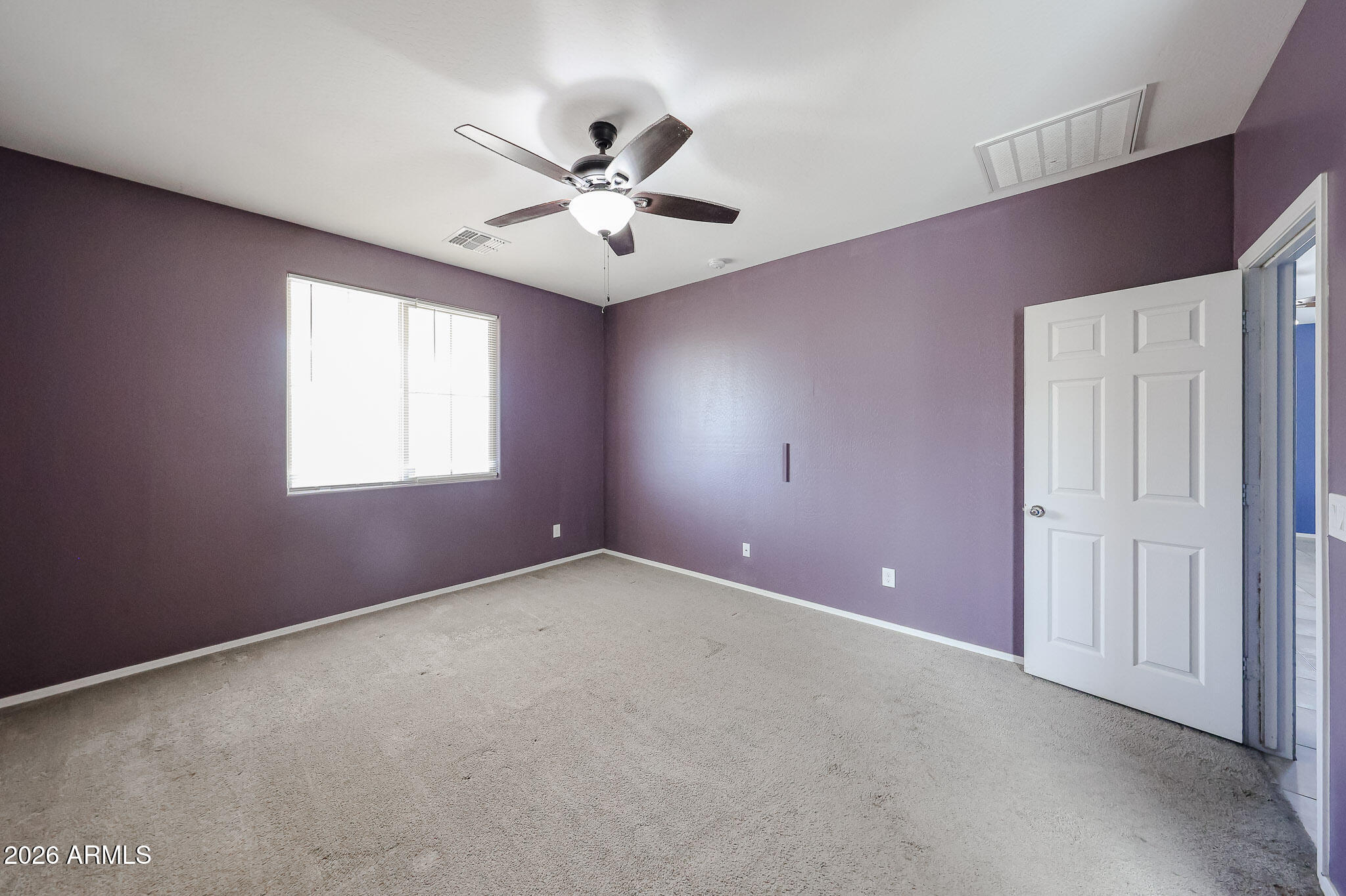 11967 West Rio Vista Lane Avondale, AZ 85323 - Photo 16 of 28 an empty room with windows and fan