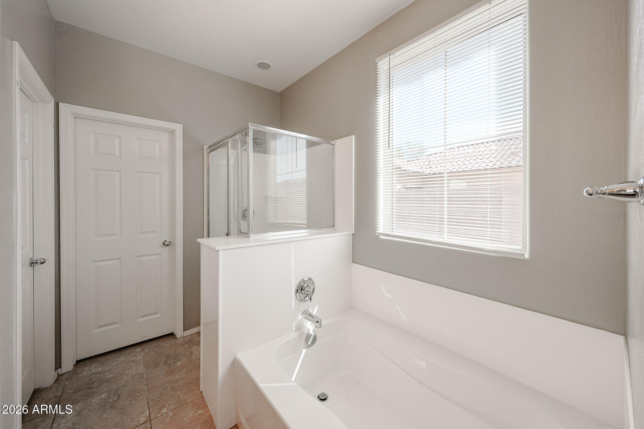 11967 West Rio Vista Lane Avondale, AZ 85323 - Photo 17 of 28 a white bath tub sitting next to a window