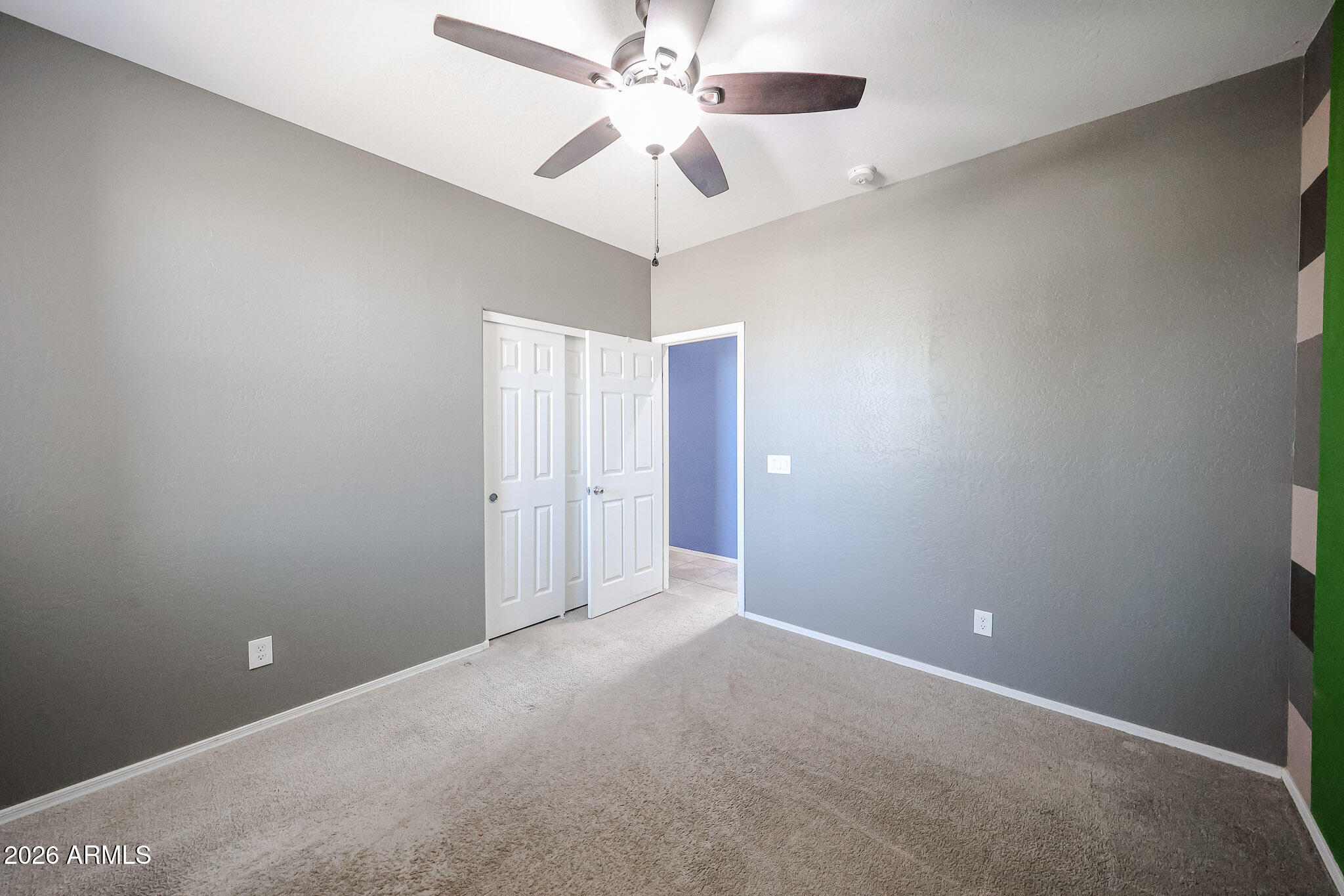 11967 West Rio Vista Lane Avondale, AZ 85323 - Photo 20 of 28 a view of an empty room and a ceiling fan