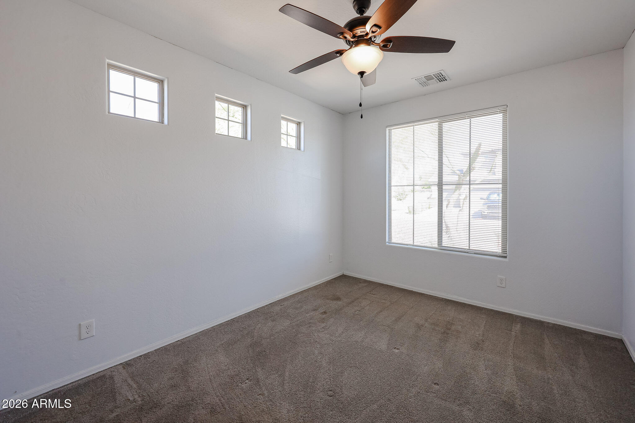 11967 West Rio Vista Lane Avondale, AZ 85323 - Photo 21 of 28 a view of an empty room with a window