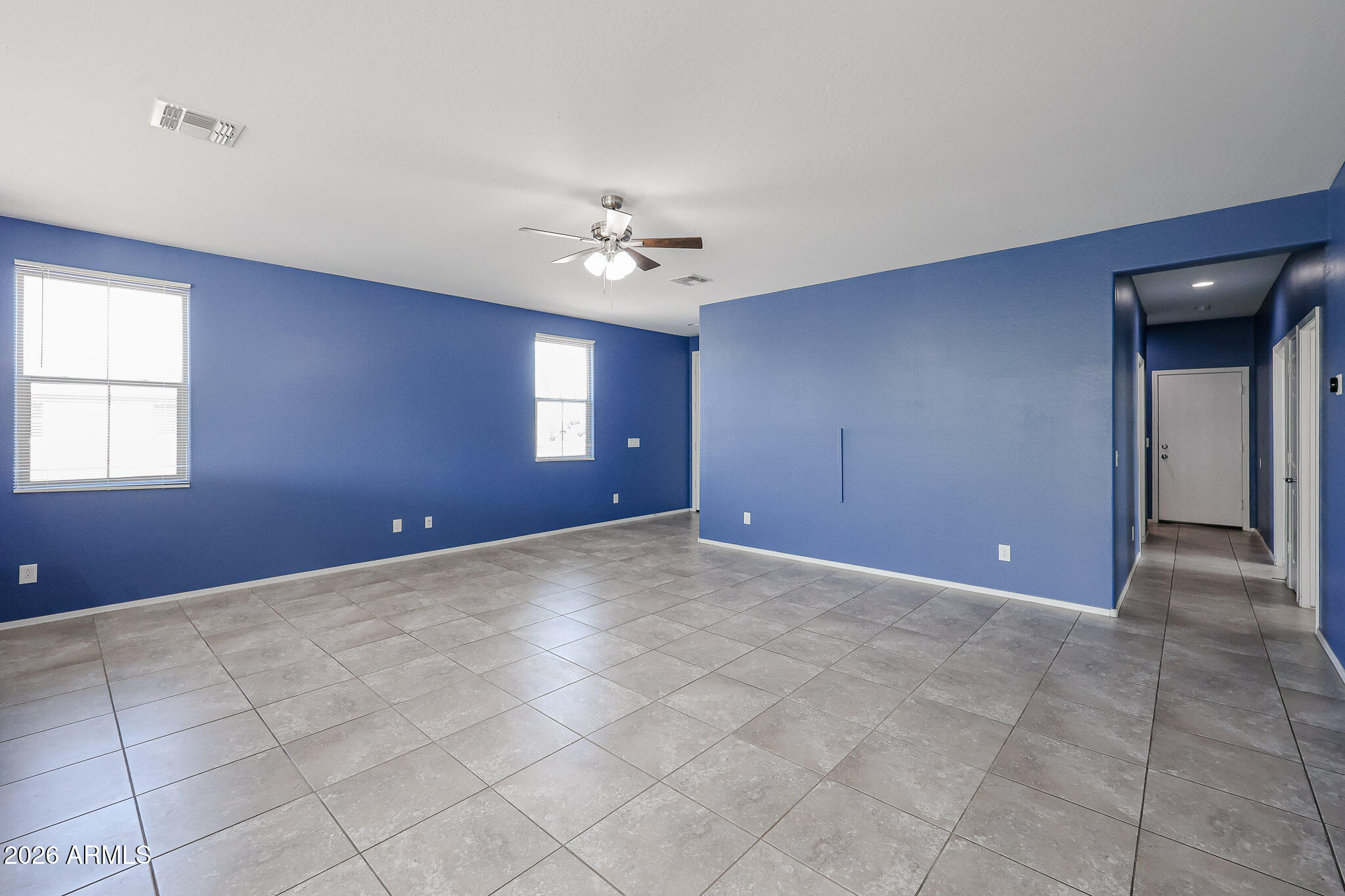 11967 West Rio Vista Lane Avondale, AZ 85323 - Photo 3 of 28 a view of an empty room with a ceiling fan
