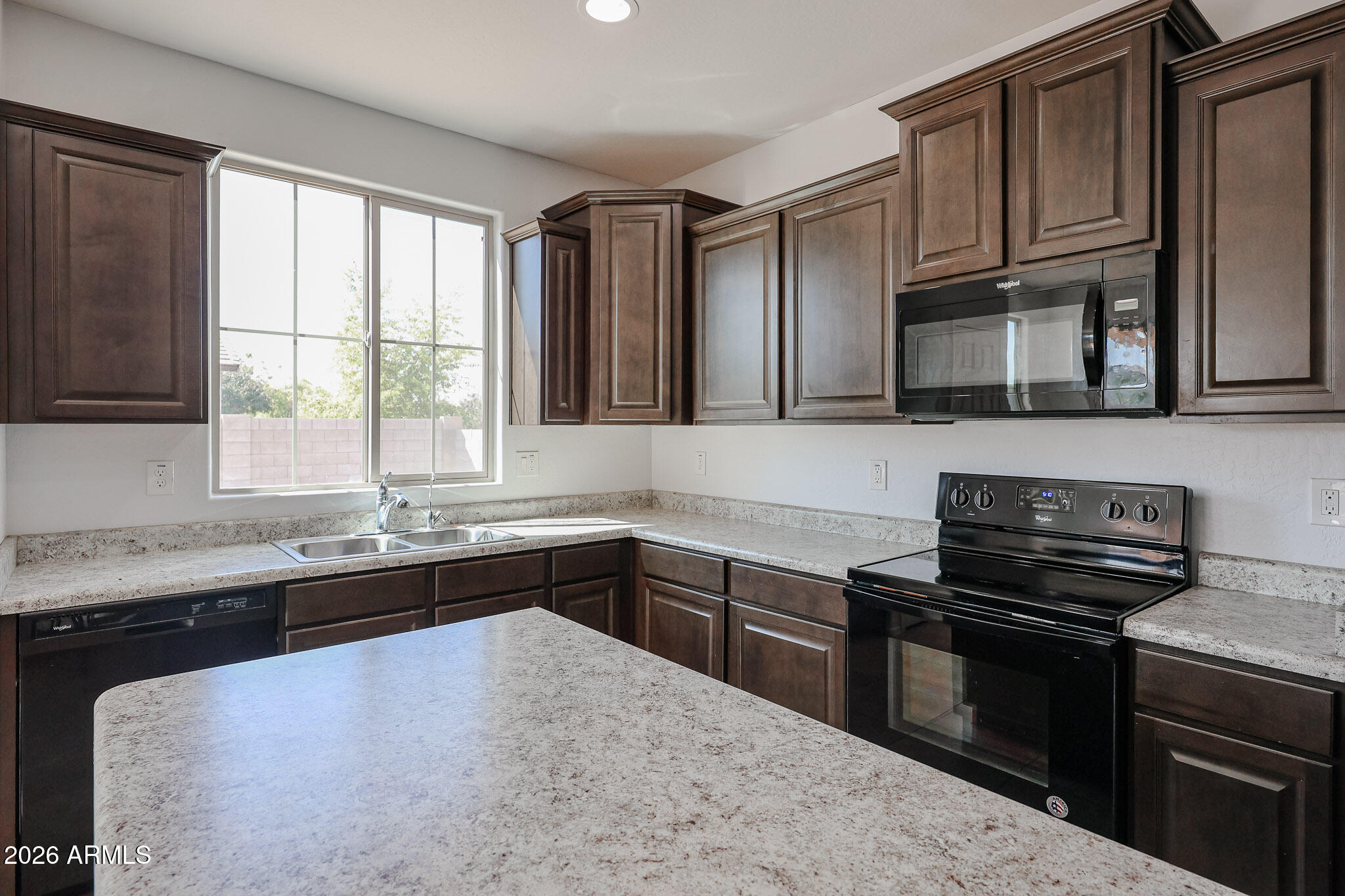 11967 West Rio Vista Lane Avondale, AZ 85323 - Photo 6 of 28 a kitchen with a sink stove and microwave