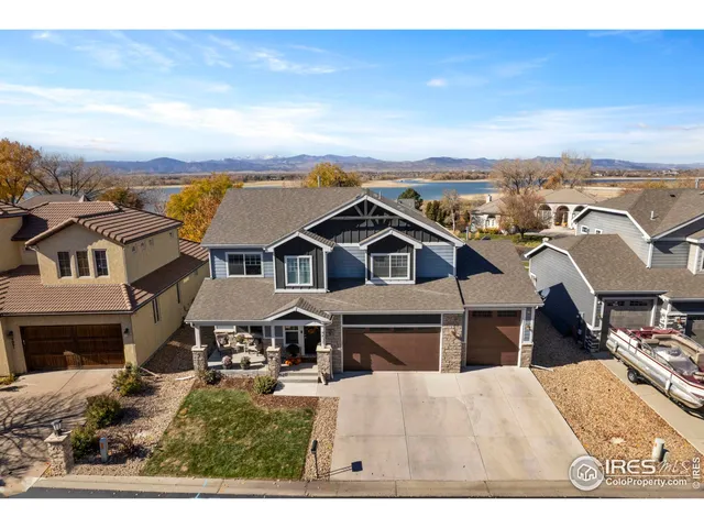 an aerial view of residential houses with yard