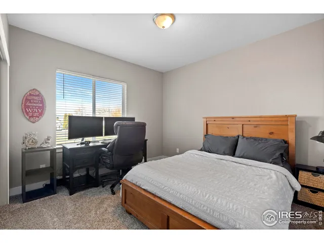 a bedroom with a bed and a desk