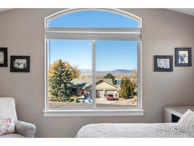 a living room with a bed and a window