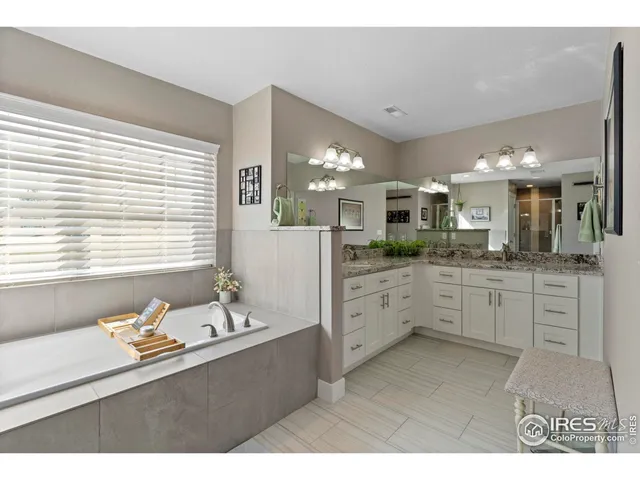 a large bathroom with a large tub sink and vanity