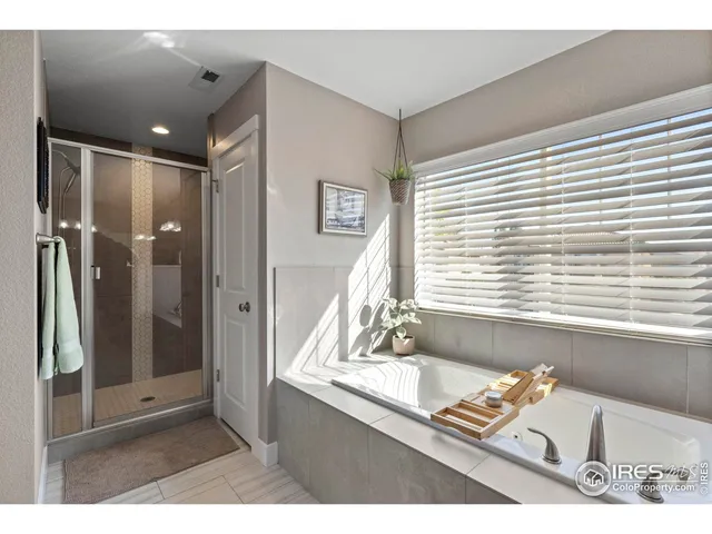 a bathroom with a tub shower and a sink