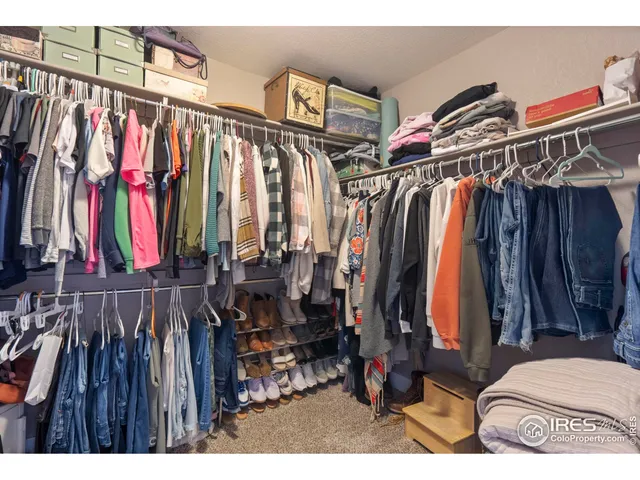 a view of walk in closet with clothes