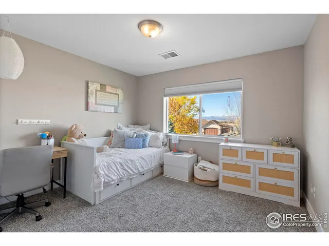 a bedroom with furniture and a window