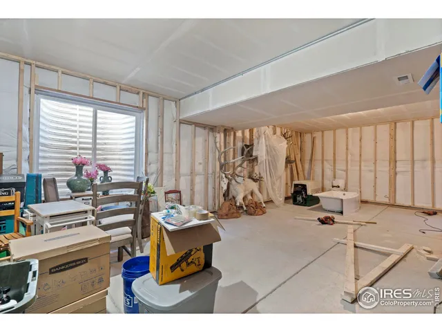 a room with gym equipment and large windows