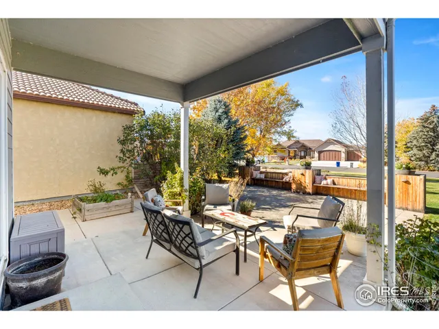 a building outdoor space with patio furniture and potted plants