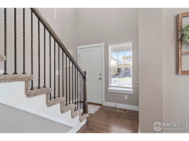 a view of an entryway with wooden floor