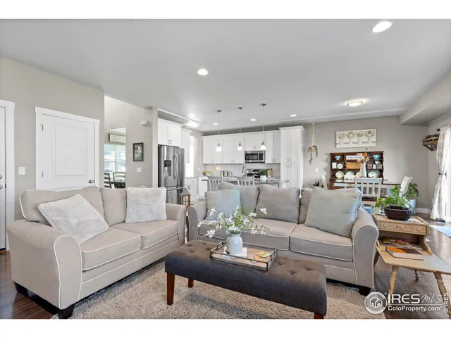 a living room with furniture and view of kitchen