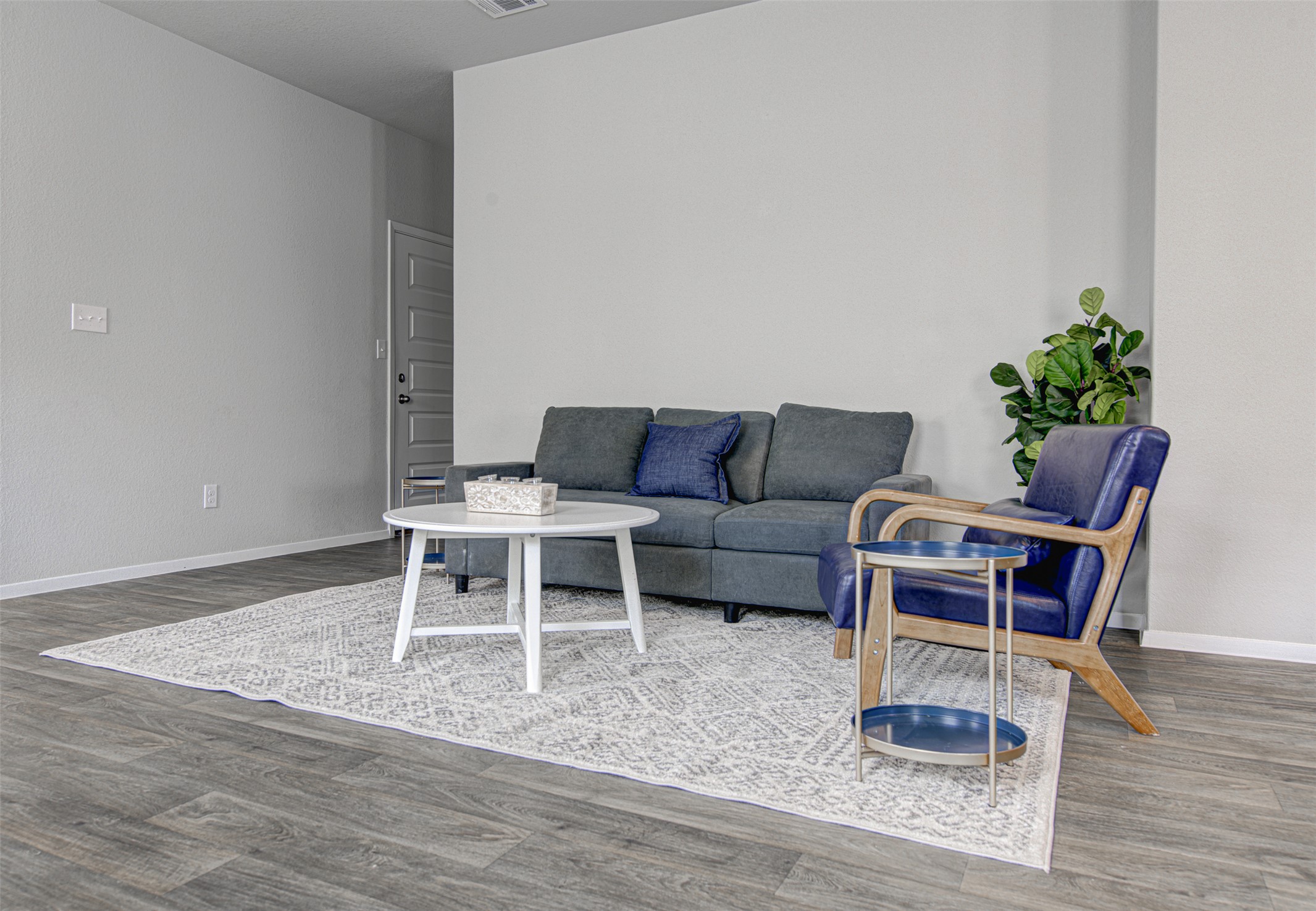 156 Tillage Road Elgin, TX 78621 - Photo 5 of 25 Neutral tones and rich wood flooring combine in this inviting living area.
