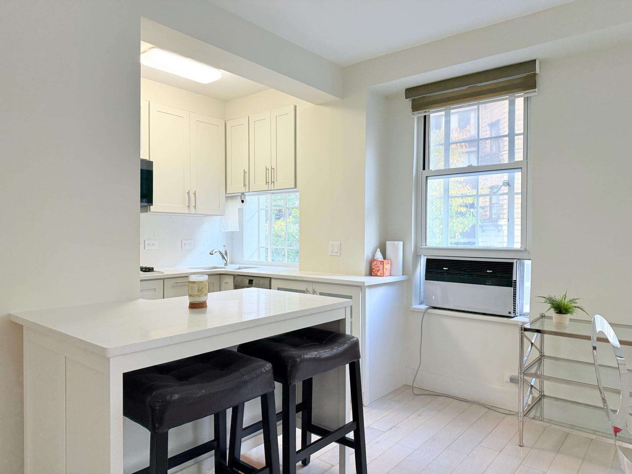a kitchen with a sink cabinets and window