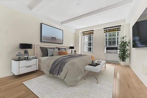 333 West 56th Street, Unit 2N Manhattan, NY 10019 - Photo 3 of 8 a spacious bedroom with a bed and flat screen tv