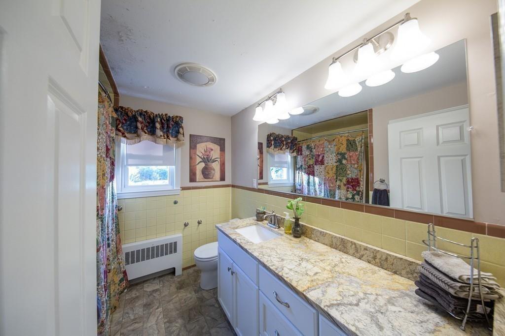 1319 Bay Road Sharon, MA 02067 - Photo 13 of 19 a bathroom with a granite countertop tub sink and mirror