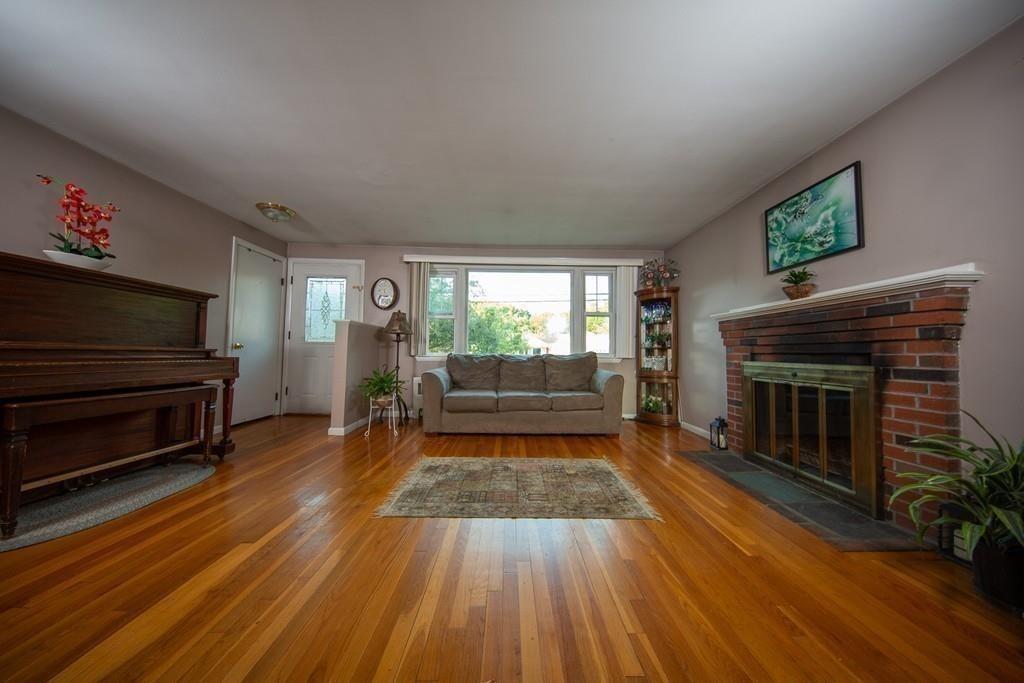 1319 Bay Road Sharon, MA 02067 - Photo 3 of 19 a living room with furniture and a fireplace