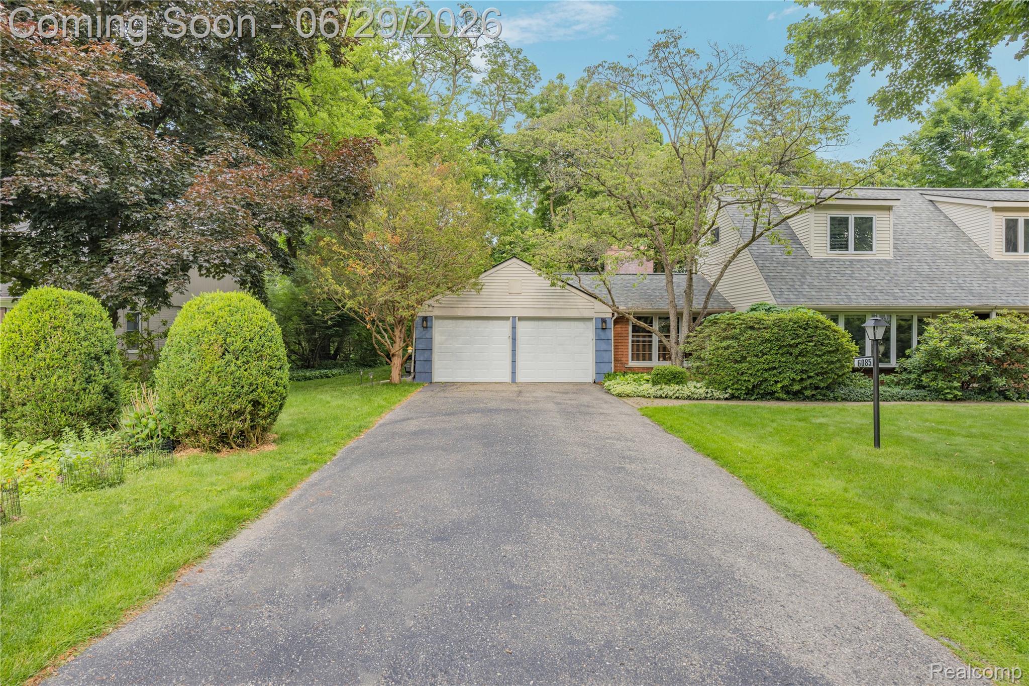 6085 Worlington Road Bloomfield Hills, MI 48301 - Photo 5 of 75 Expansive paved driveway leading to a two-car garage with white doors