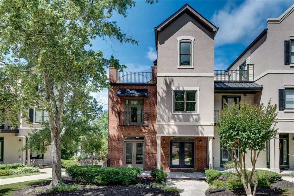 a front view of a house with plants and garden