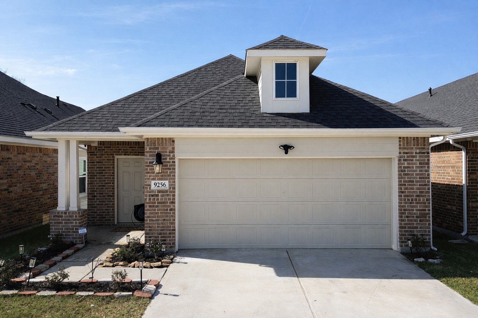 a front view of a house with garage