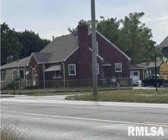 a aerial view of a house next to a yard