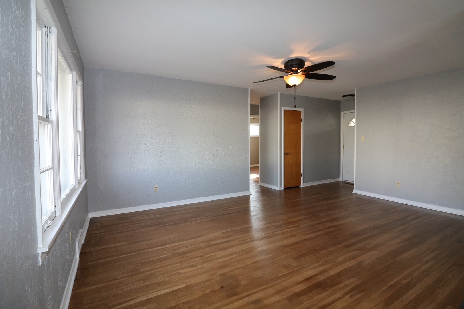 1307 South Jasper Street Decatur, IL 62521 - Photo 4 of 16 wooden floor in an empty room with a window