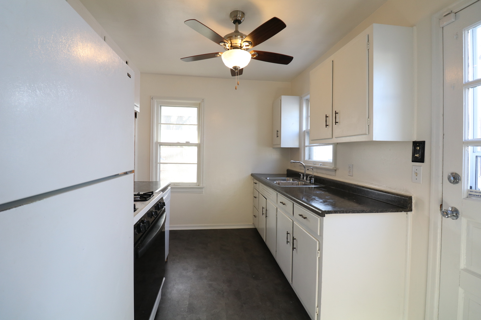 1307 South Jasper Street Decatur, IL 62521 - Photo 8 of 16 a kitchen with stainless steel appliances granite countertop a stove a refrigerator and a cabinets