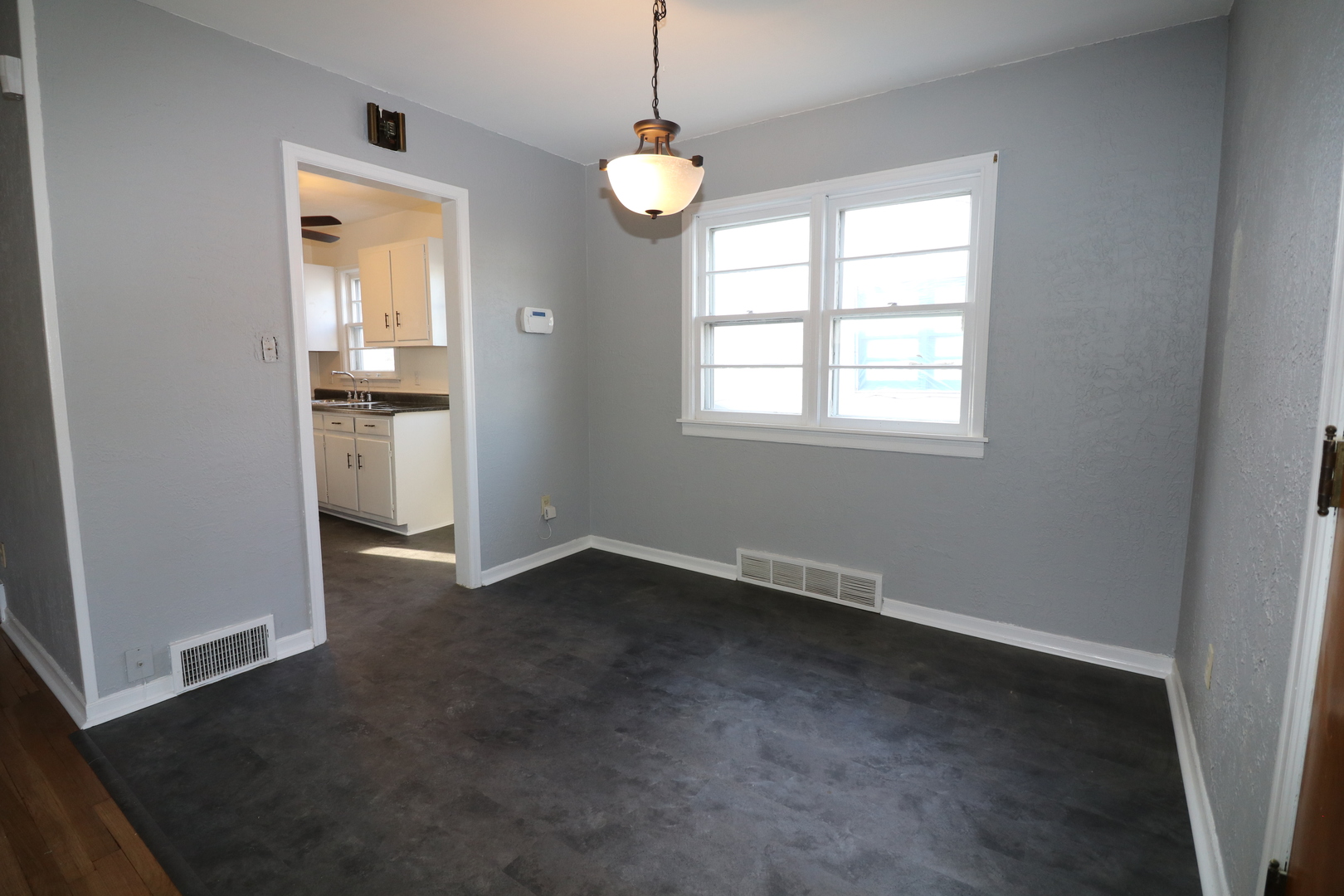 1307 South Jasper Street Decatur, IL 62521 - Photo 10 of 16 an empty room with windows and cabinet