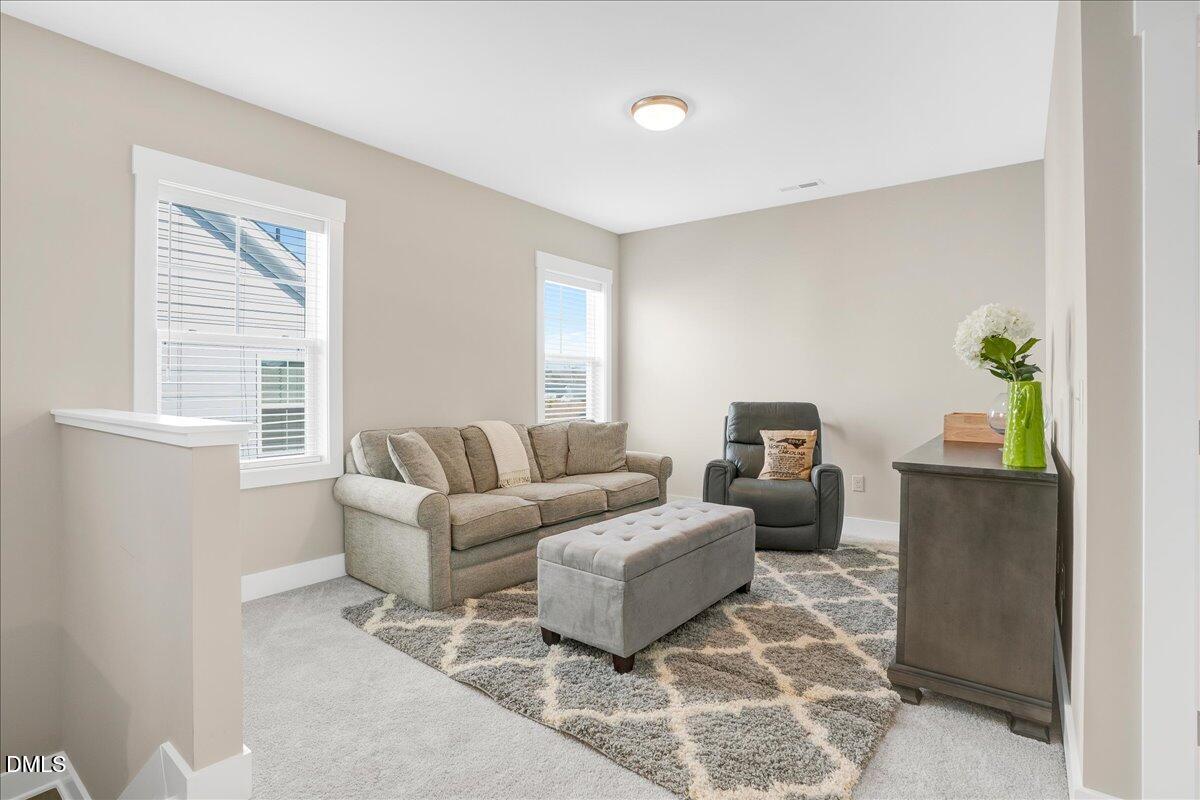 1105 Logperch Way Wendell, NC 27591 - Photo 17 of 29 a living room with furniture and a window