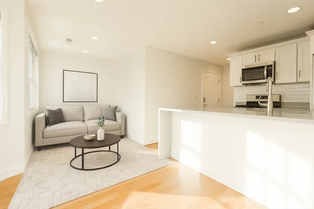 a view of a hallway with wooden floor and closet area