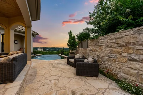 a view of couches in the patio with a fire pit