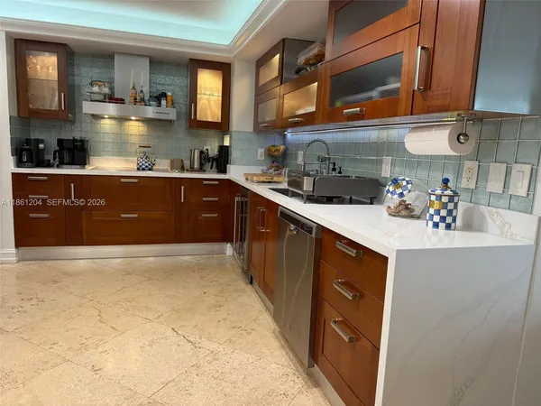 a kitchen with a sink and a stove top oven
