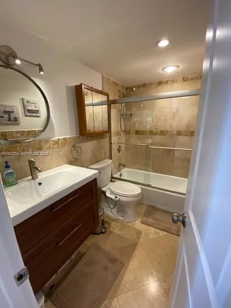 a bathroom with a double vanity sink toilet and shower