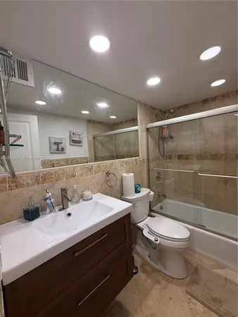 a bathroom with a glass door shower