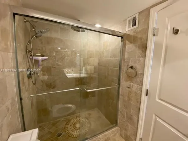 a spacious bedroom with a bed and large windows