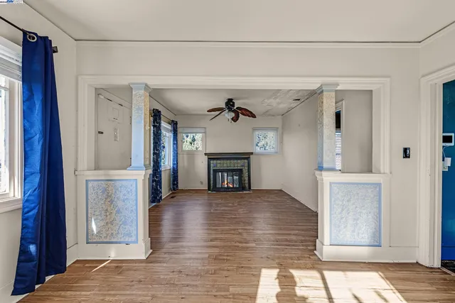 a view of a hallway with wooden floor and a fireplace