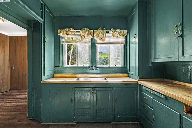 a room with pool table and windows