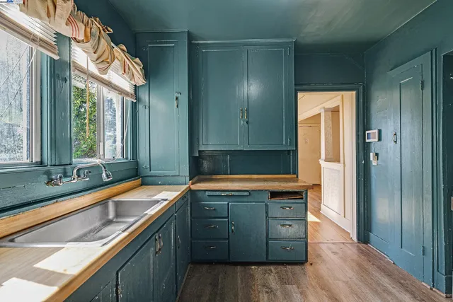 a kitchen with stainless steel appliances granite countertop a sink and a refrigerator