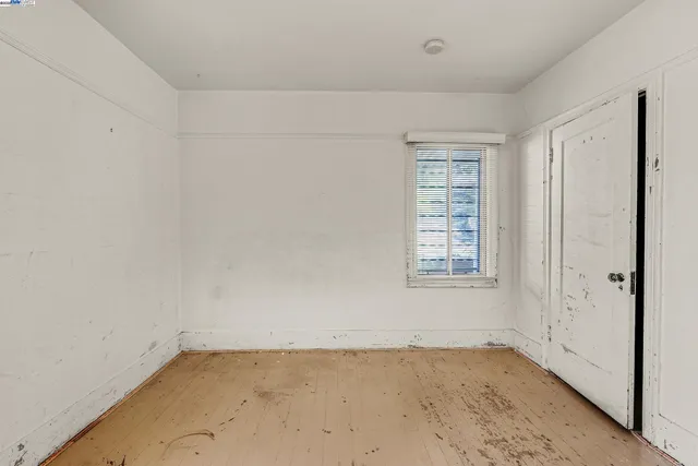 a view of a room with wooden floor and a bathroom